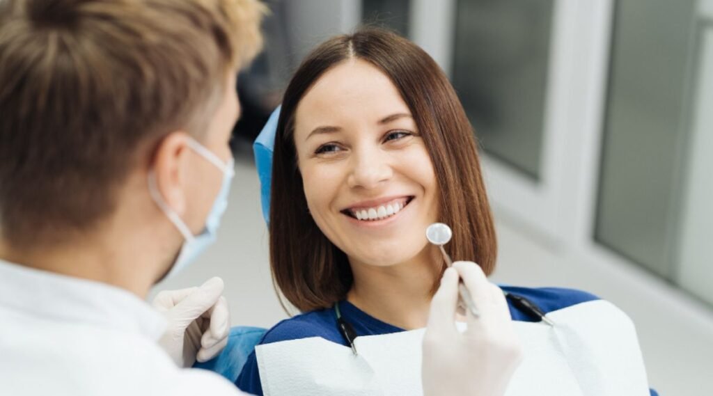 Male professional dentist with gloves and mask at City Dental Hospital, the top dentist near me, discussing the patient's teeth treatment plan.