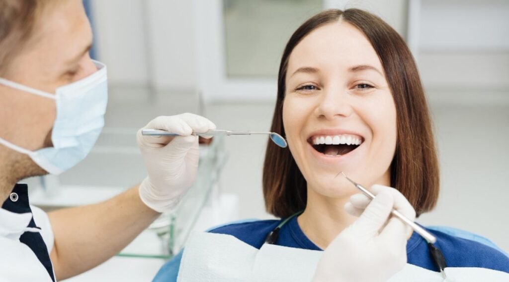 male dentist examining a young woman's teeth at City Dental Hospital, the best dentist in India